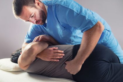 Chiropractor performing a spinal adjustment.