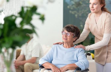 Elderly woman with caregiver in wheelchair